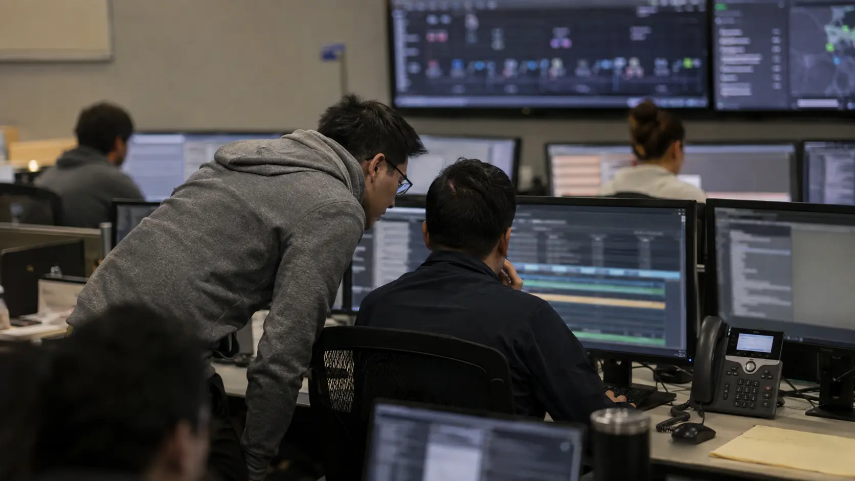 Security analysts responding to a live incident in a real security operations center